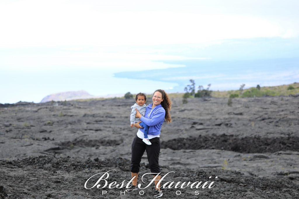 Mother daughter Family photo overlooking the vast lava and ocean landscapes at Volcano National Park on the Big Island of Hawaii. Photography by Pasha of Best Hawaii Photos.